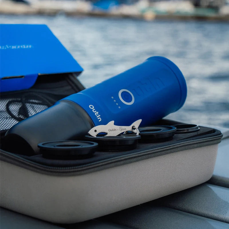 Ocean Blue thermos and espresso accessories in storage case by the water.