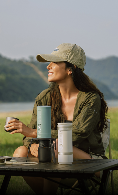 OutIn Nano2 portable espresso machine held in hand